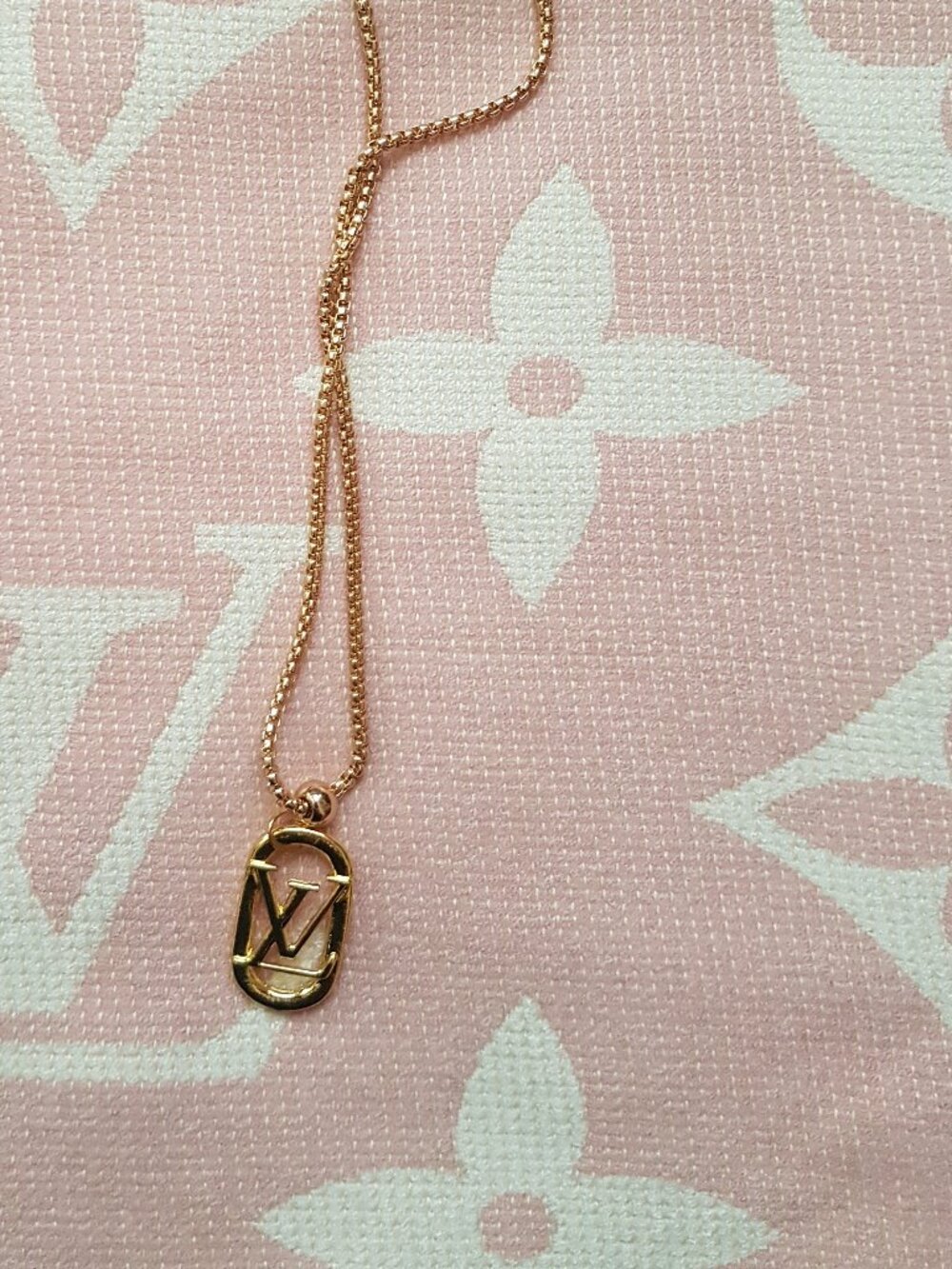 Gold  tone charm pendant with iconic initial